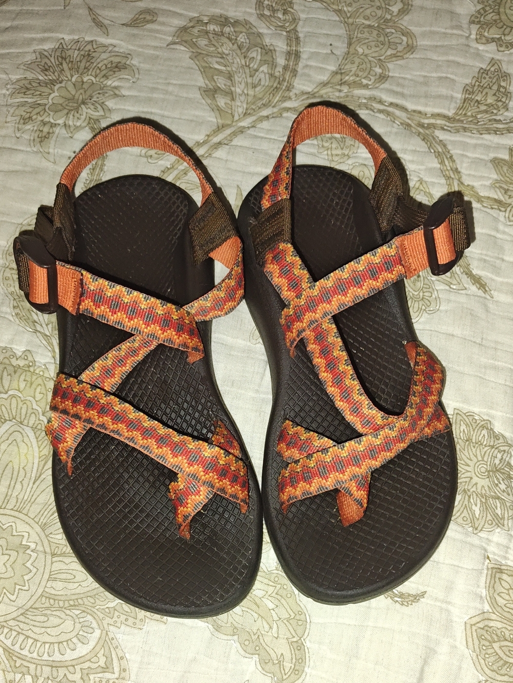 Chaco Z/2 sandals featuring a vibrant orange and black geometric patterned strap